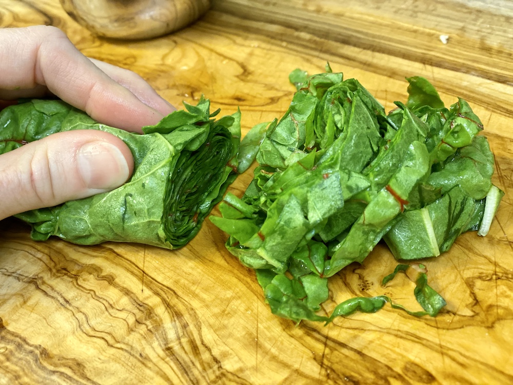 chopping spring green leaves