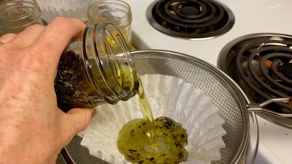 pouring mint oil into strainer