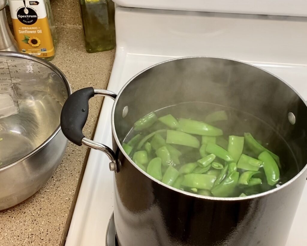 Snow peas in boiling water